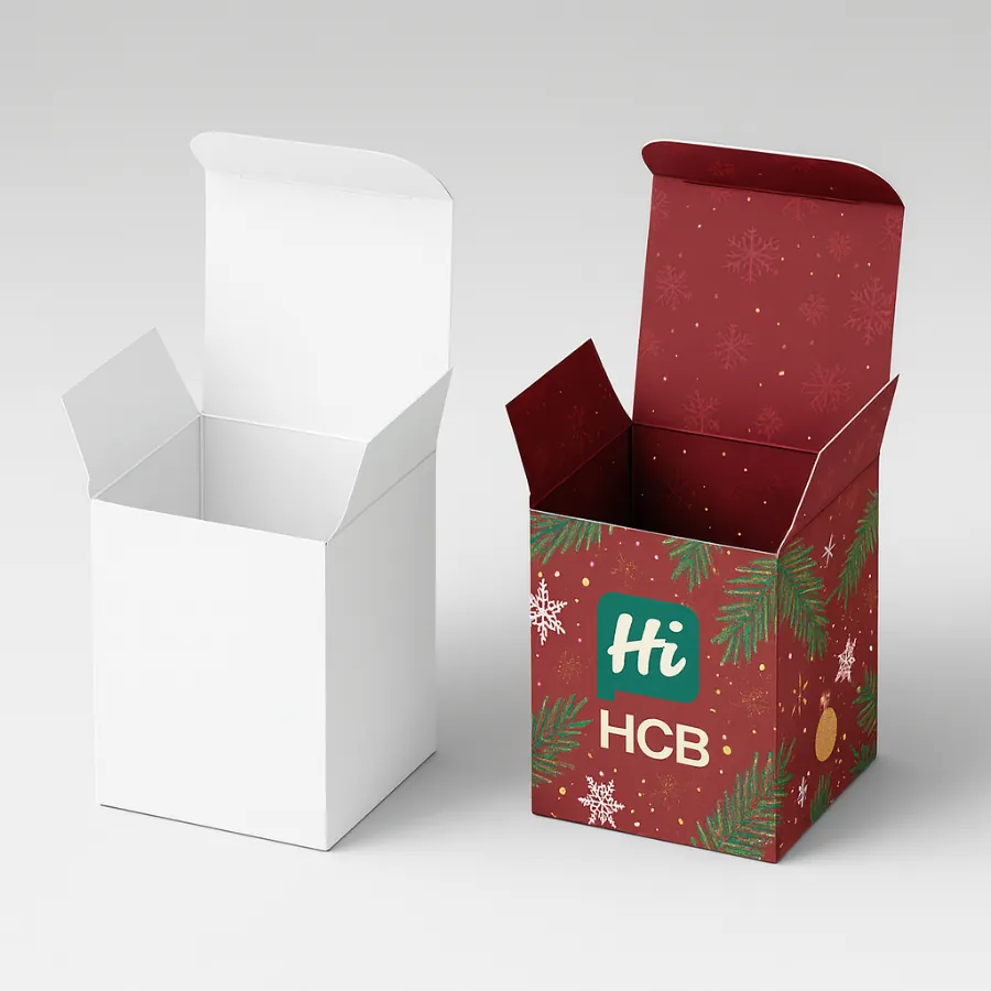 Two open square cardboard candle boxes- one plain white- one deep red Christmas design- class=